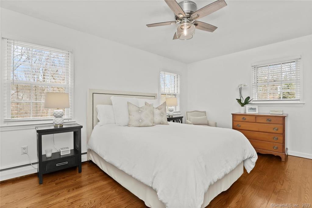 183 Frogtown Road New Canaan, CT 06840 - Photo 15 of 37 a bedroom with a bed and a chandelier