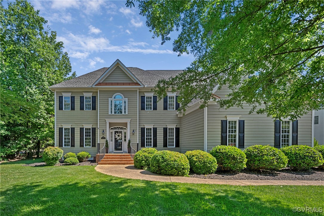 a front view of a house with garden and porch