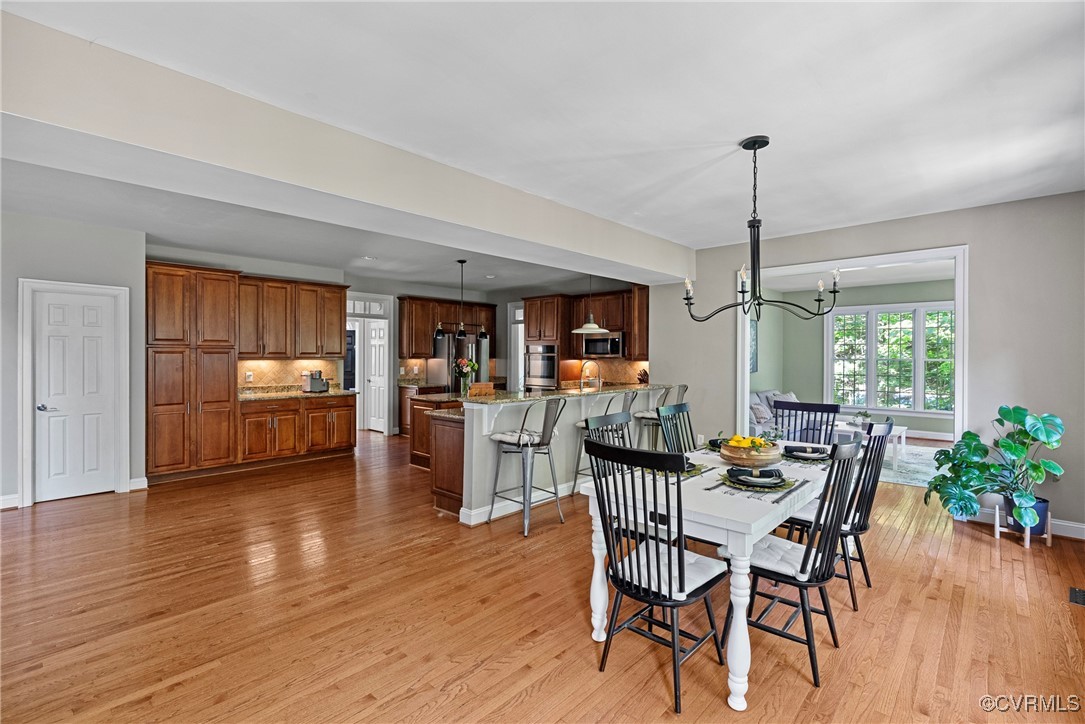14136 Rigney Drive Midlothian, VA 23113 - Photo 12 of 50 a view of a dining room and livingroom with furniture wooden floor a chandelier