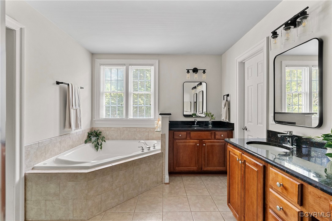 14136 Rigney Drive Midlothian, VA 23113 - Photo 31 of 50 a bathroom with a granite countertop tub sink and mirror