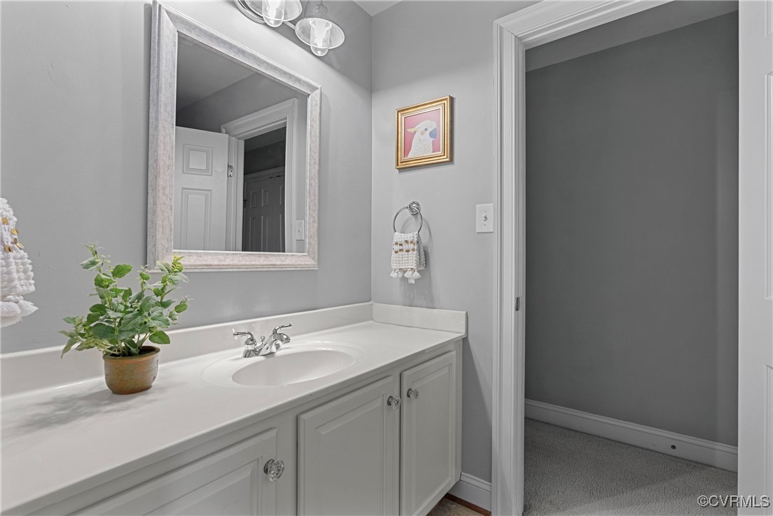 14136 Rigney Drive Midlothian, VA 23113 - Photo 34 of 50 a bathroom with a sink a vanity and a mirror