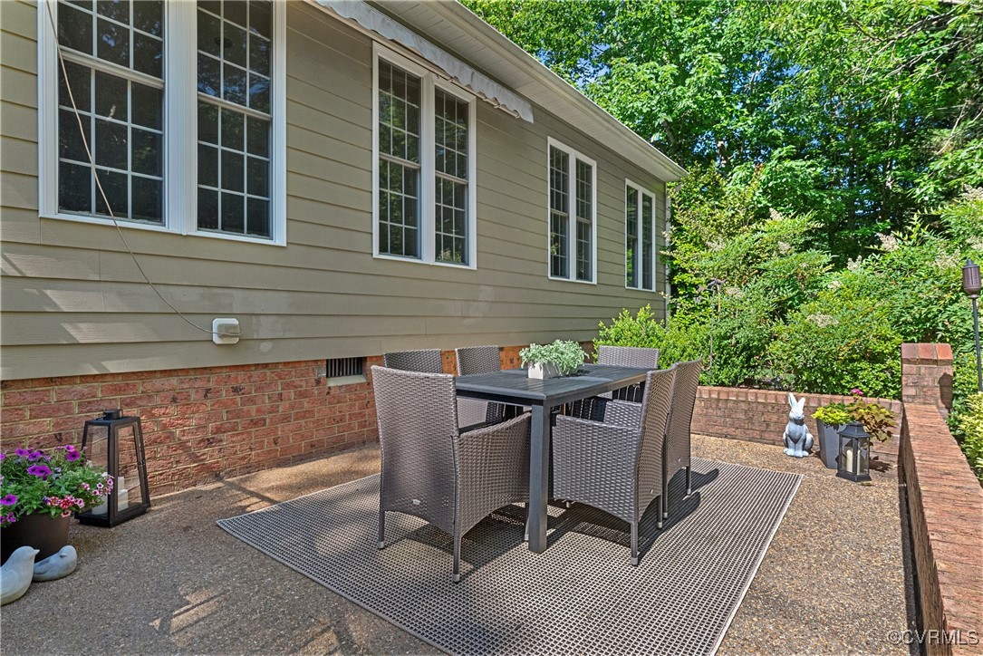 14136 Rigney Drive Midlothian, VA 23113 - Photo 44 of 50 a view of a patio with table and chairs and potted plants