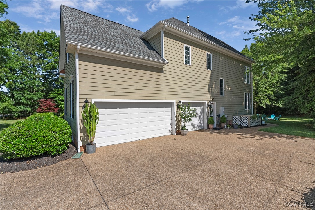 14136 Rigney Drive Midlothian, VA 23113 - Photo 47 of 50 a front view of a house with a yard and garage