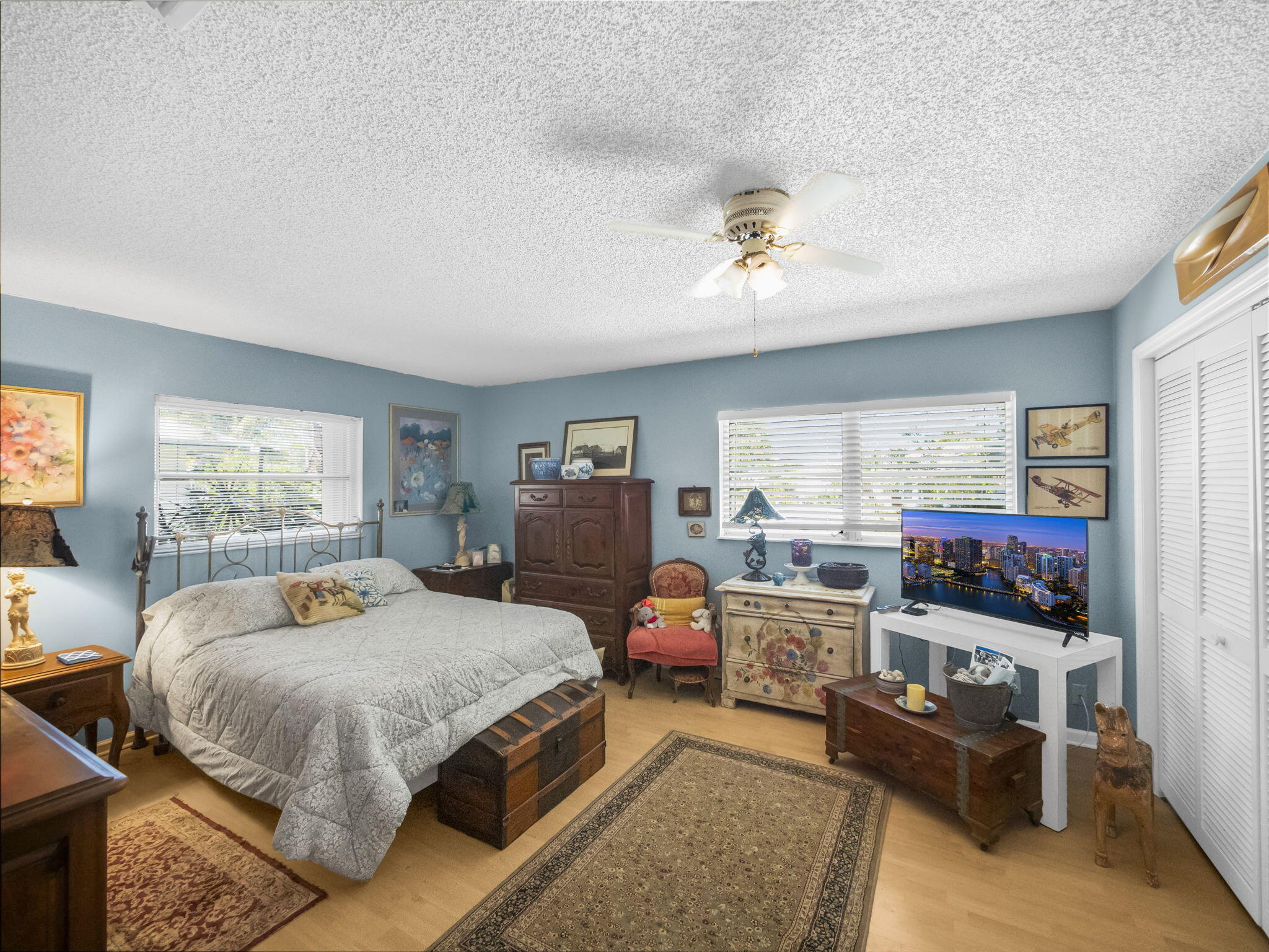 18390 Southeast Courtview Circle Jupiter, FL 33469 - Photo 12 of 16 a bedroom with a bed a couch and large windows