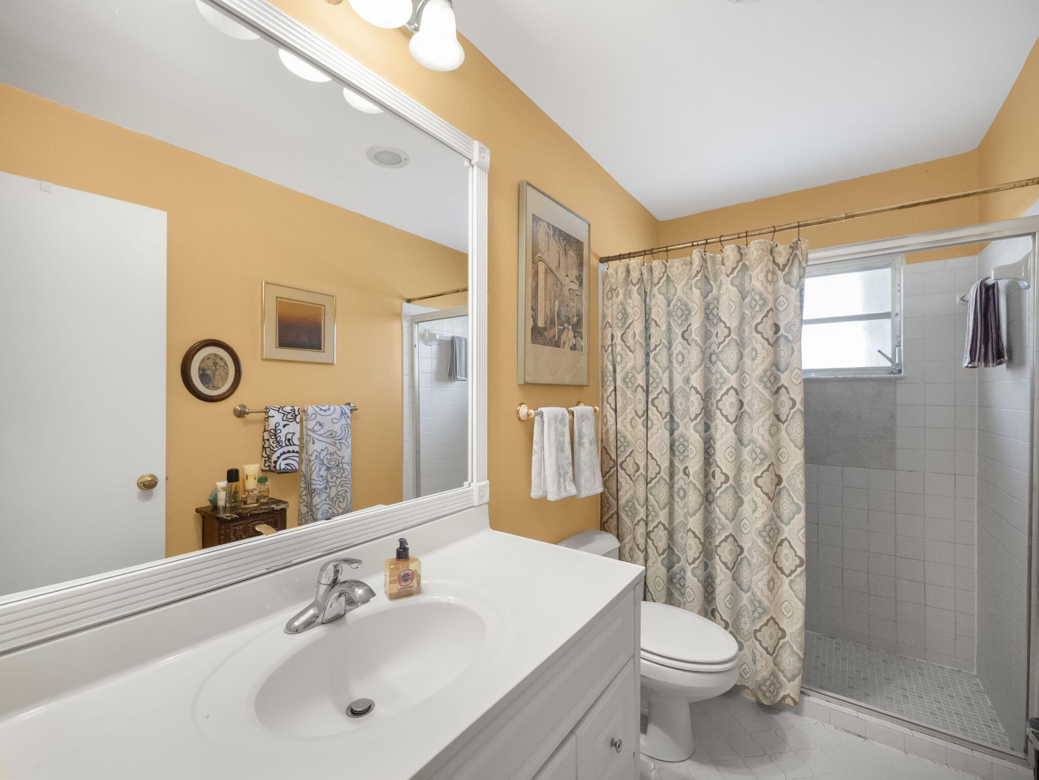 18390 Southeast Courtview Circle Jupiter, FL 33469 - Photo 13 of 16 a bathroom with a sink a toilet and shower