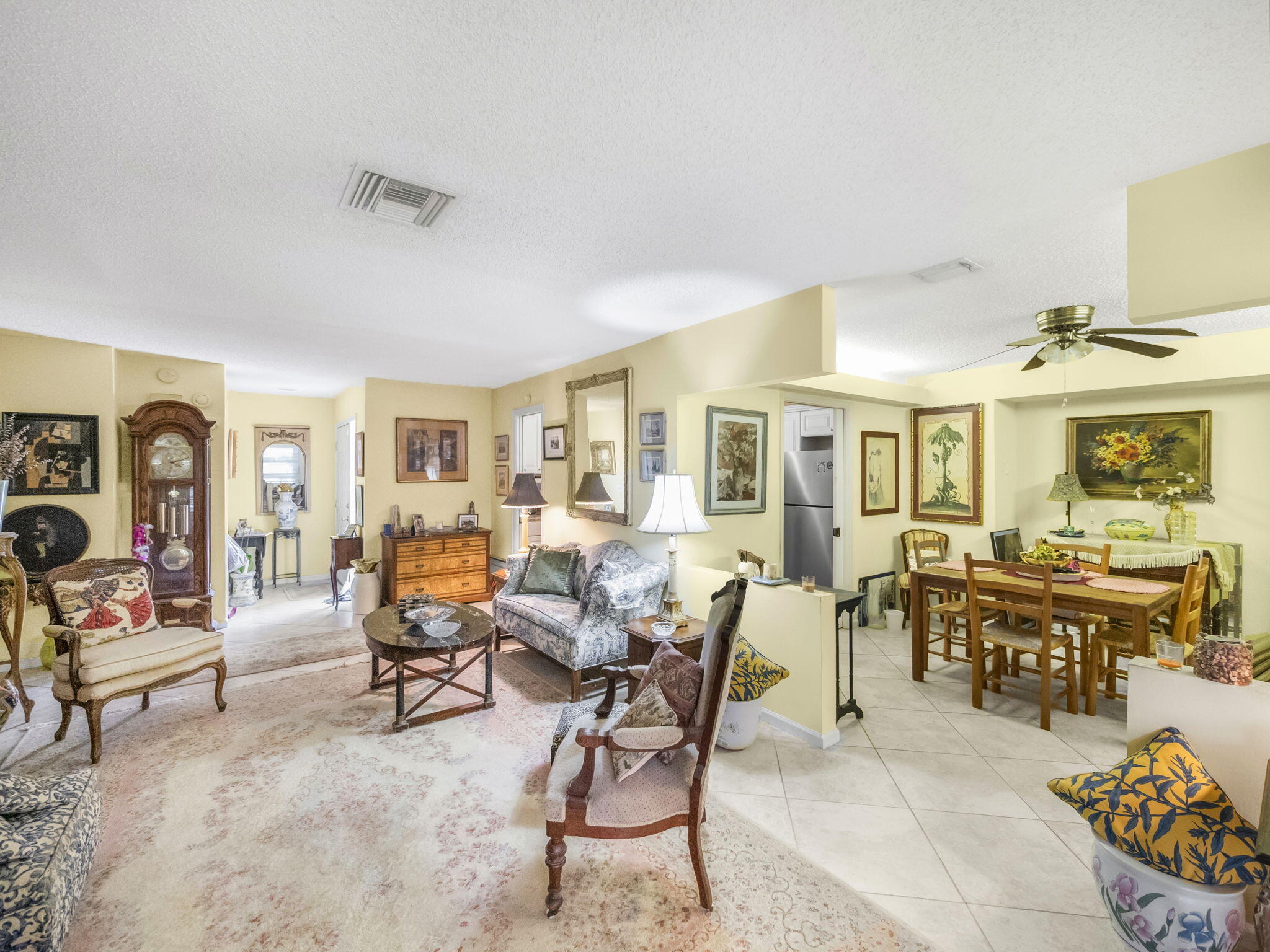 18390 Southeast Courtview Circle Jupiter, FL 33469 - Photo 7 of 16 a living room with furniture and a dining table with chairs