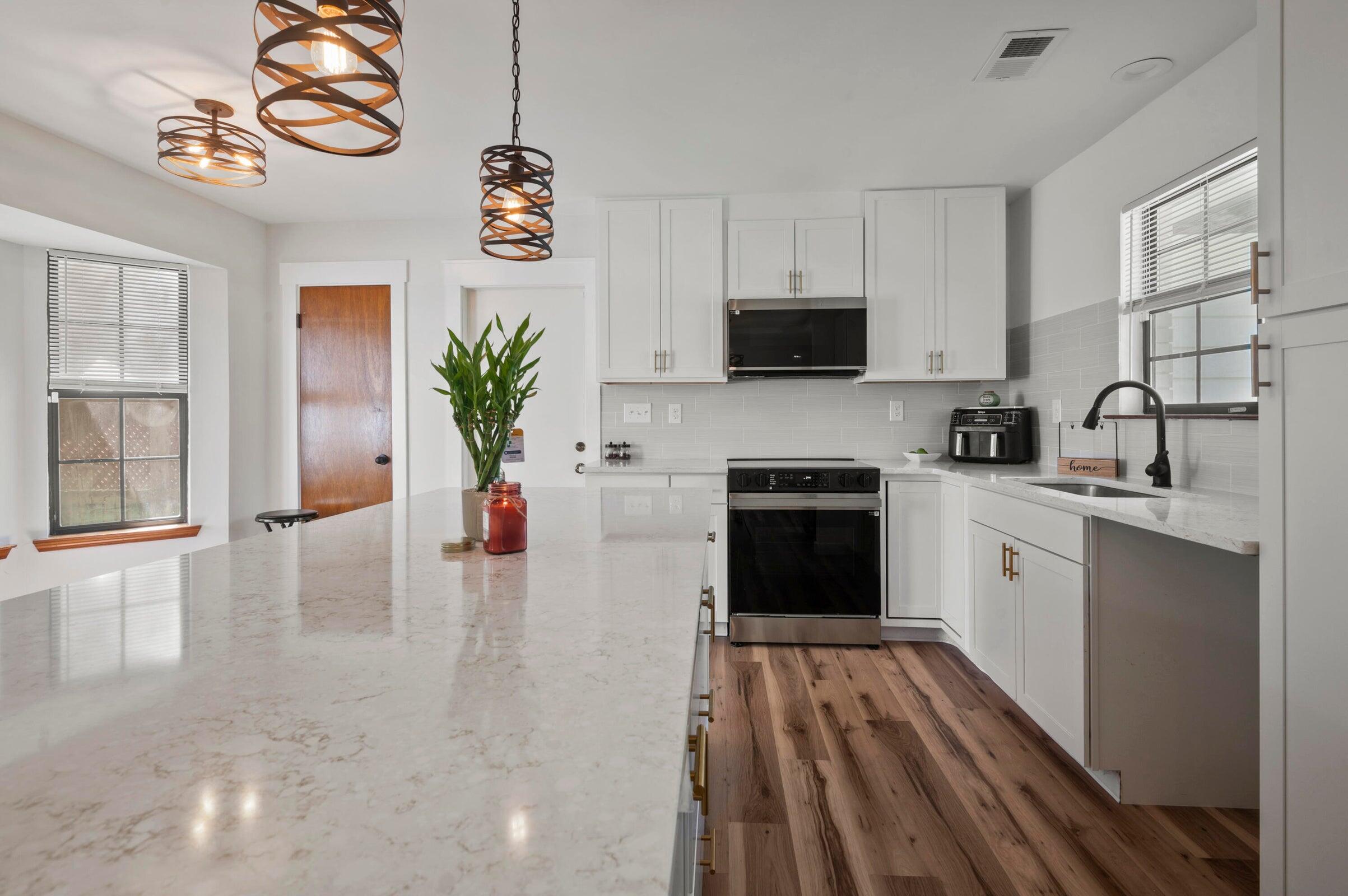 403 Juniper Drive Crestview, FL 32536 - Photo 4 of 25 a kitchen with a white stove top oven a sink a counter space and cabinets