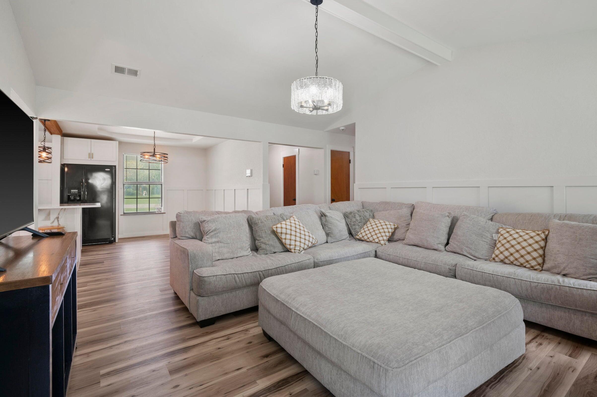 403 Juniper Drive Crestview, FL 32536 - Photo 10 of 25 a living room with furniture wooden floor and a chandelier