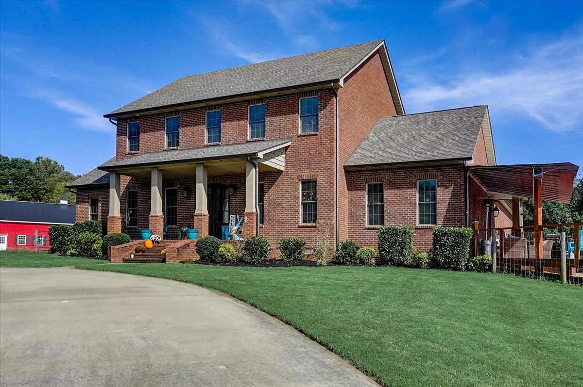 2115 Port Royal Road Adams, TN 37010 - Photo 3 of 49 front view of a house with a yard