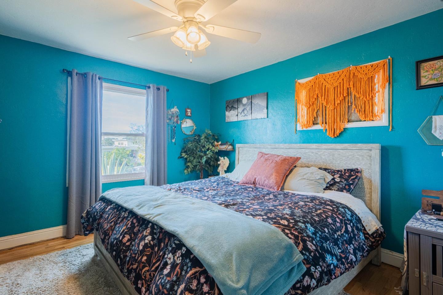 2080 Buchanan Street Seaside, CA 93955 - Photo 20 of 28 a bedroom with a large bed and a chandelier