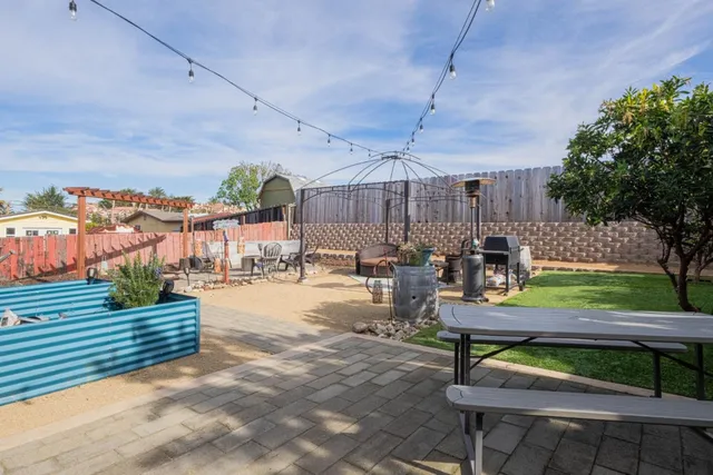 a view of a backyard with sitting area