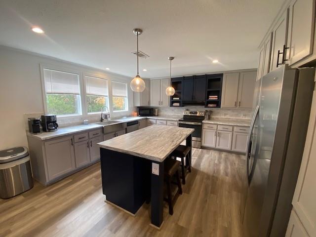 12154 County Road 331A Terrell, TX 75161 - Photo 8 of 31 a kitchen with kitchen island a counter top space a sink a refrigerator and a stove