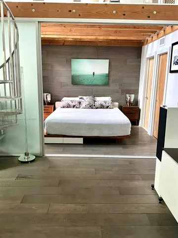 a bedroom with a bed and a mirror