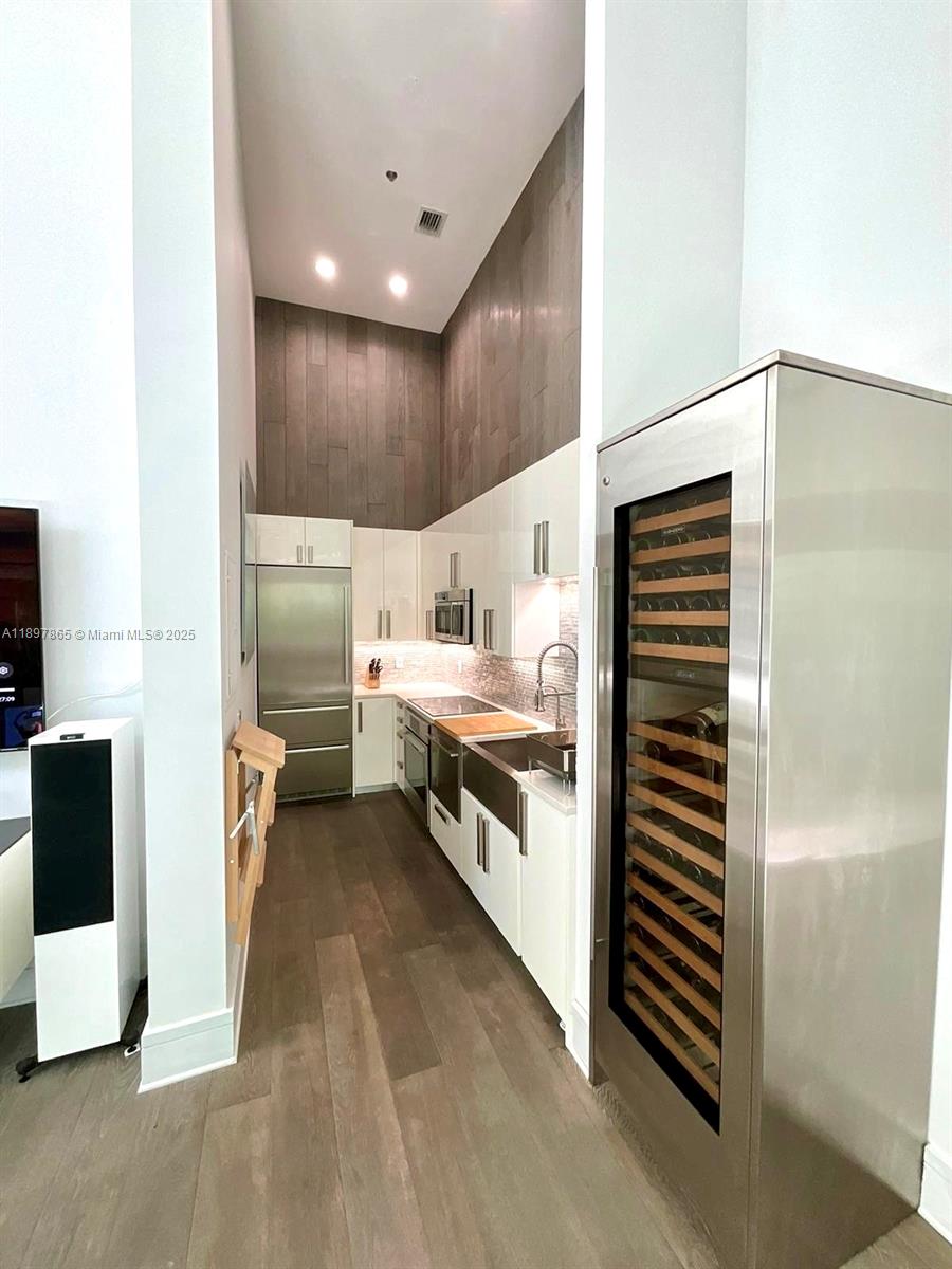 221 Jefferson Avenue, Unit 4 Miami Beach, FL 33139 - Photo 15 of 34 a kitchen with stainless steel appliances kitchen island granite countertop a refrigerator and a stove
