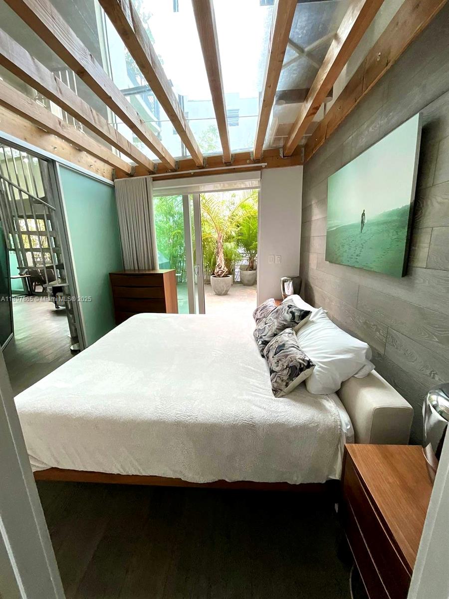 221 Jefferson Avenue, Unit 4 Miami Beach, FL 33139 - Photo 17 of 34 a bedroom with a bed and a large window