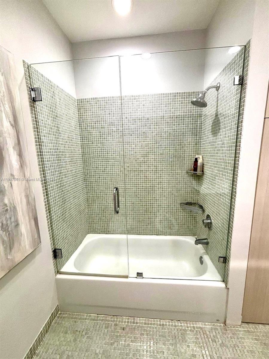 221 Jefferson Avenue, Unit 4 Miami Beach, FL 33139 - Photo 21 of 34 a bathroom with a white bath tub a shower and a sink