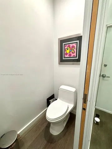 a white toilet sitting next to a small bathroom