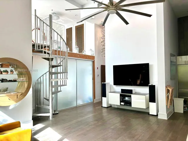 a view of a livingroom with furniture and a flat screen tv