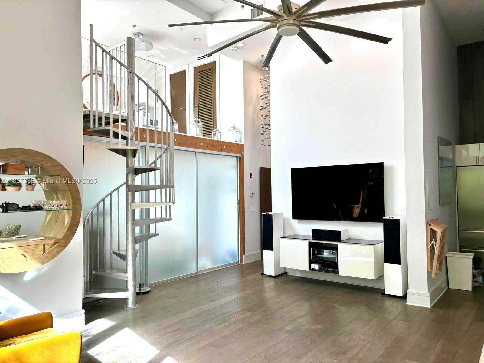 221 Jefferson Avenue, Unit 4 Miami Beach, FL 33139 - Photo 4 of 34 a view of a livingroom with furniture and a flat screen tv