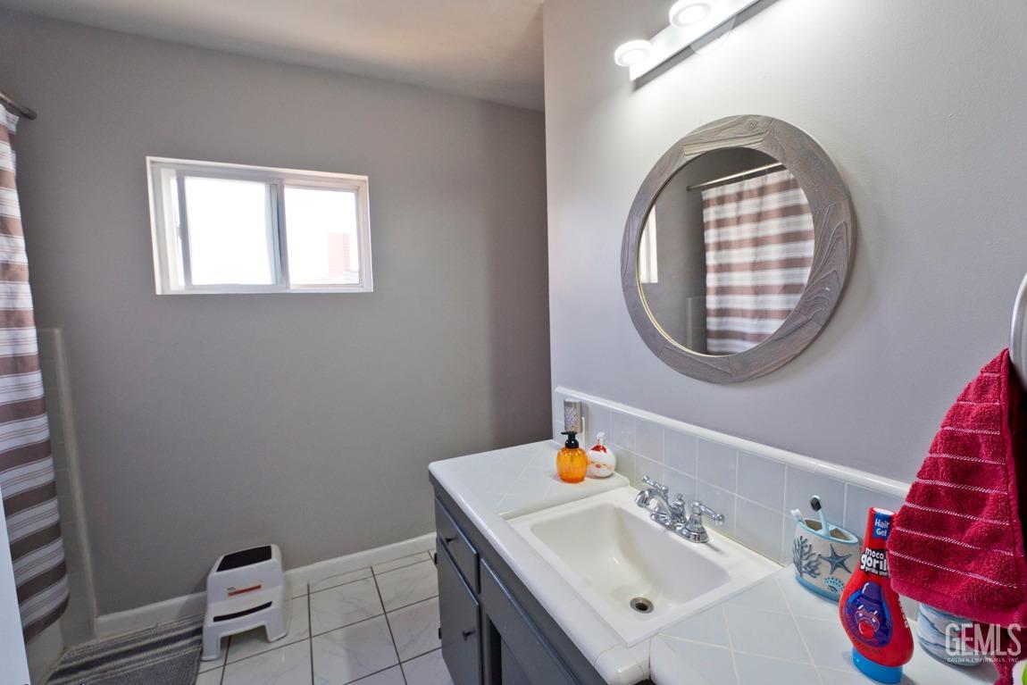 Undisclosed Address Bakersfield, CA 93306 - Photo 14 of 20 a bathroom with a sink mirror and vanity