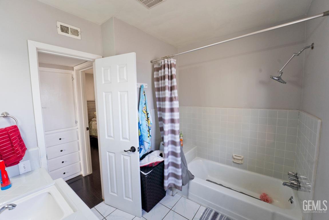 Undisclosed Address Bakersfield, CA 93306 - Photo 16 of 20 a bathroom with a bathtub and shower