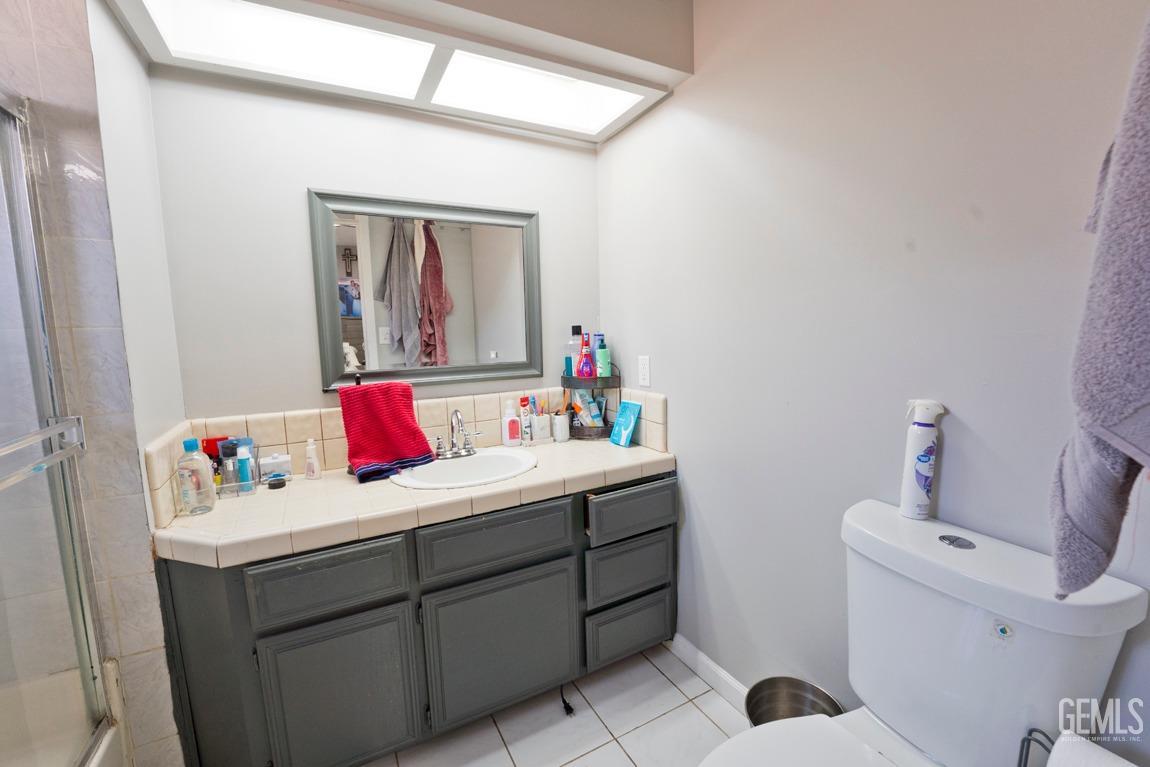 Undisclosed Address Bakersfield, CA 93306 - Photo 17 of 20 a bathroom with a sink vanity mirror and toilet