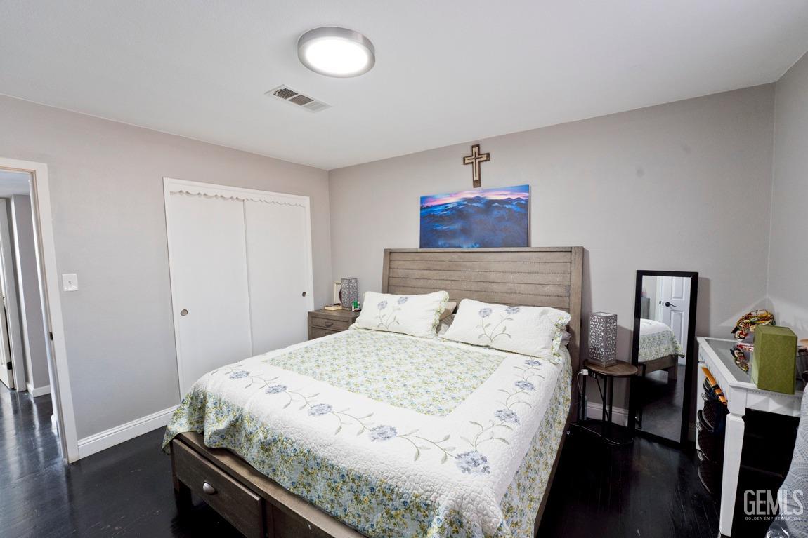 Undisclosed Address Bakersfield, CA 93306 - Photo 18 of 20 a bedroom with a bed and wooden floor
