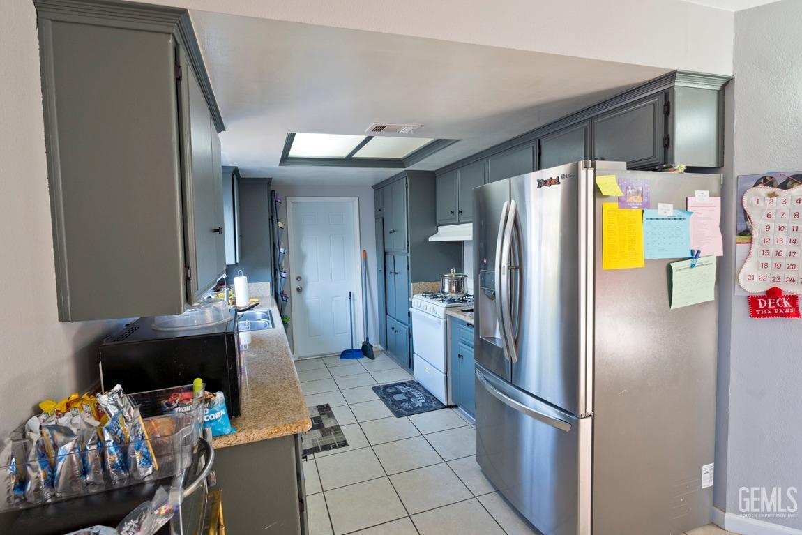 Undisclosed Address Bakersfield, CA 93306 - Photo 10 of 20 a kitchen with stainless steel appliances a refrigerator and a stove