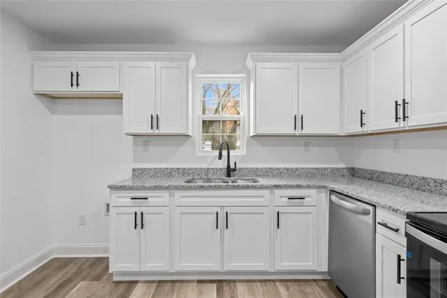 a kitchen with white cabinets and a sink