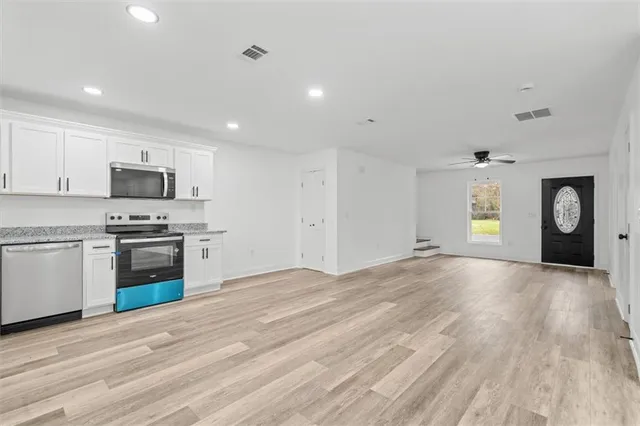 a view of a kitchen with a sink and a stove top oven