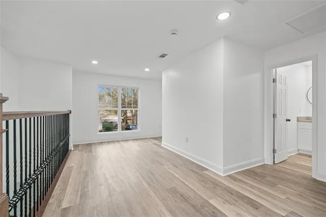a bathroom with a granite countertop toilet sink and mirror