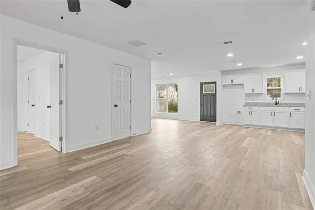 a view of a kitchen with refrigerator and a sink