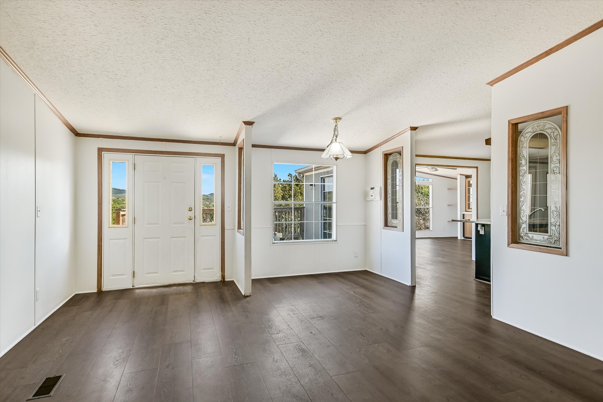 217 Rousey Street Canyon Lake, TX 78133 - Photo 12 of 25 a view of a big room with wooden floor and windows