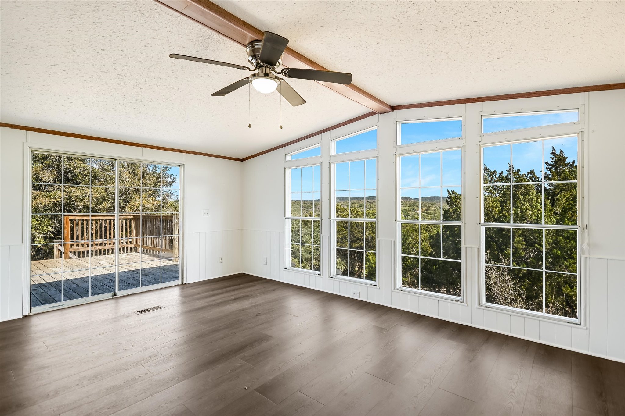 217 Rousey Street Canyon Lake, TX 78133 - Photo 14 of 25 a view of empty room with wooden floor and fan