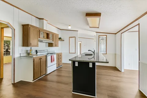 a kitchen with stainless steel appliances granite countertop a stove and a refrigerator