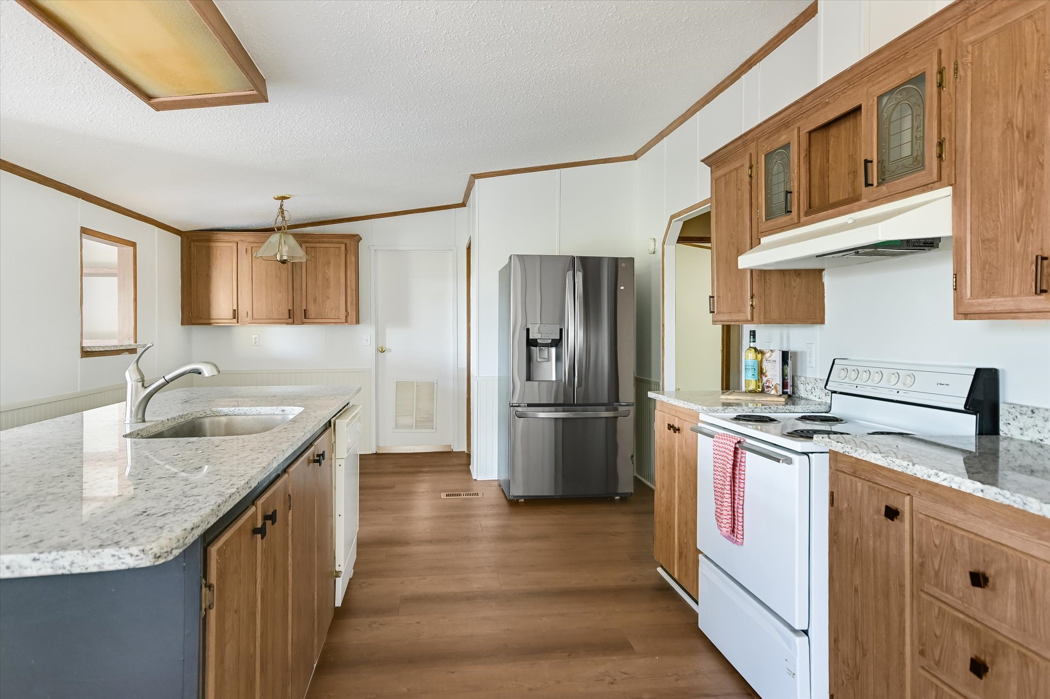 217 Rousey Street Canyon Lake, TX 78133 - Photo 17 of 25 a kitchen with stainless steel appliances granite countertop a sink stove and refrigerator