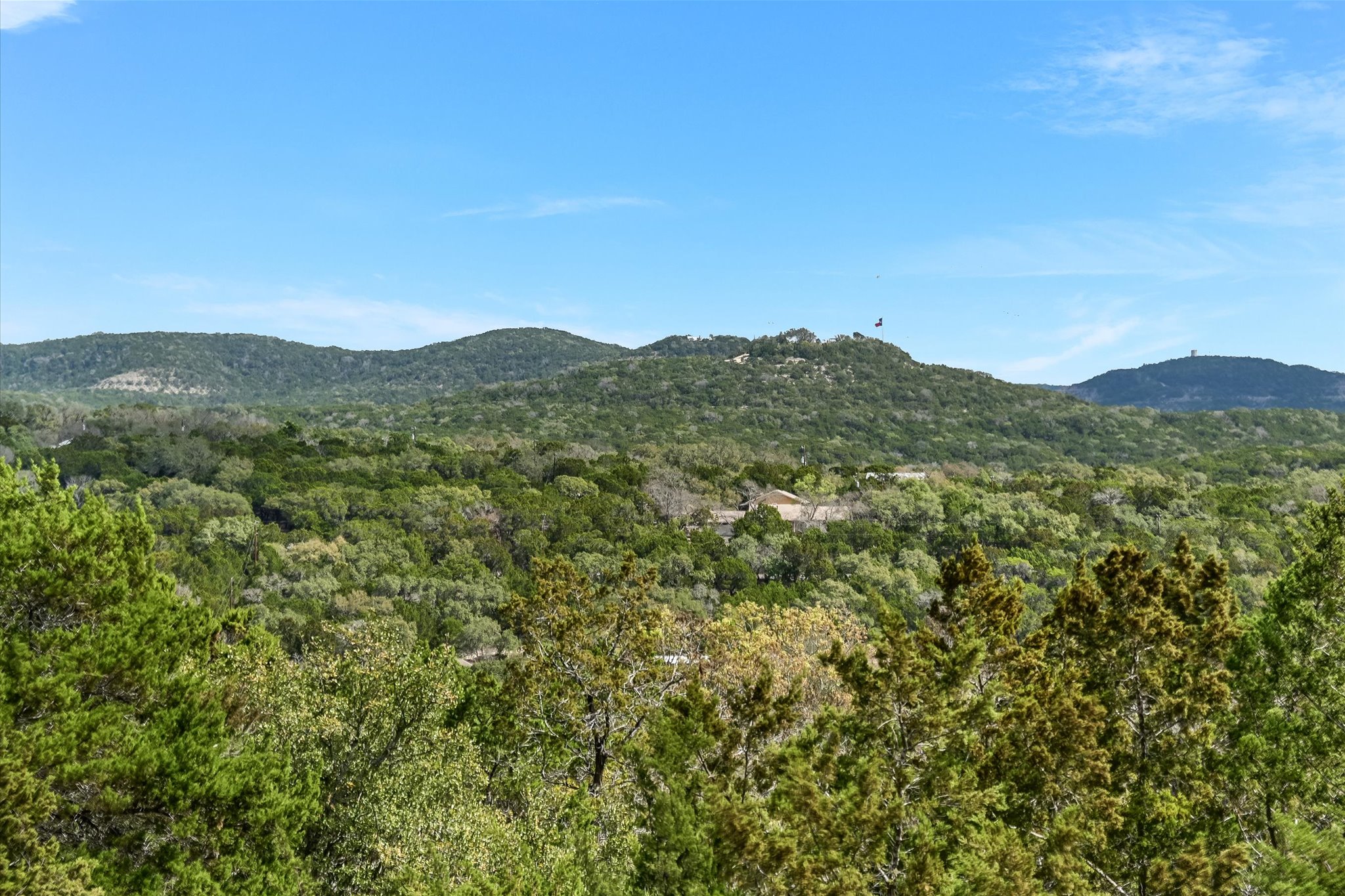 217 Rousey Street Canyon Lake, TX 78133 - Photo 23 of 25 a view of a mountain range with lush green forest