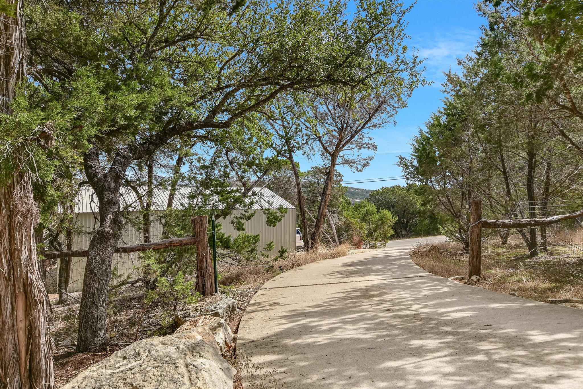 217 Rousey Street Canyon Lake, TX 78133 - Photo 3 of 25 a road view with large trees
