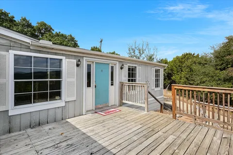a view of a house with a wooden deck