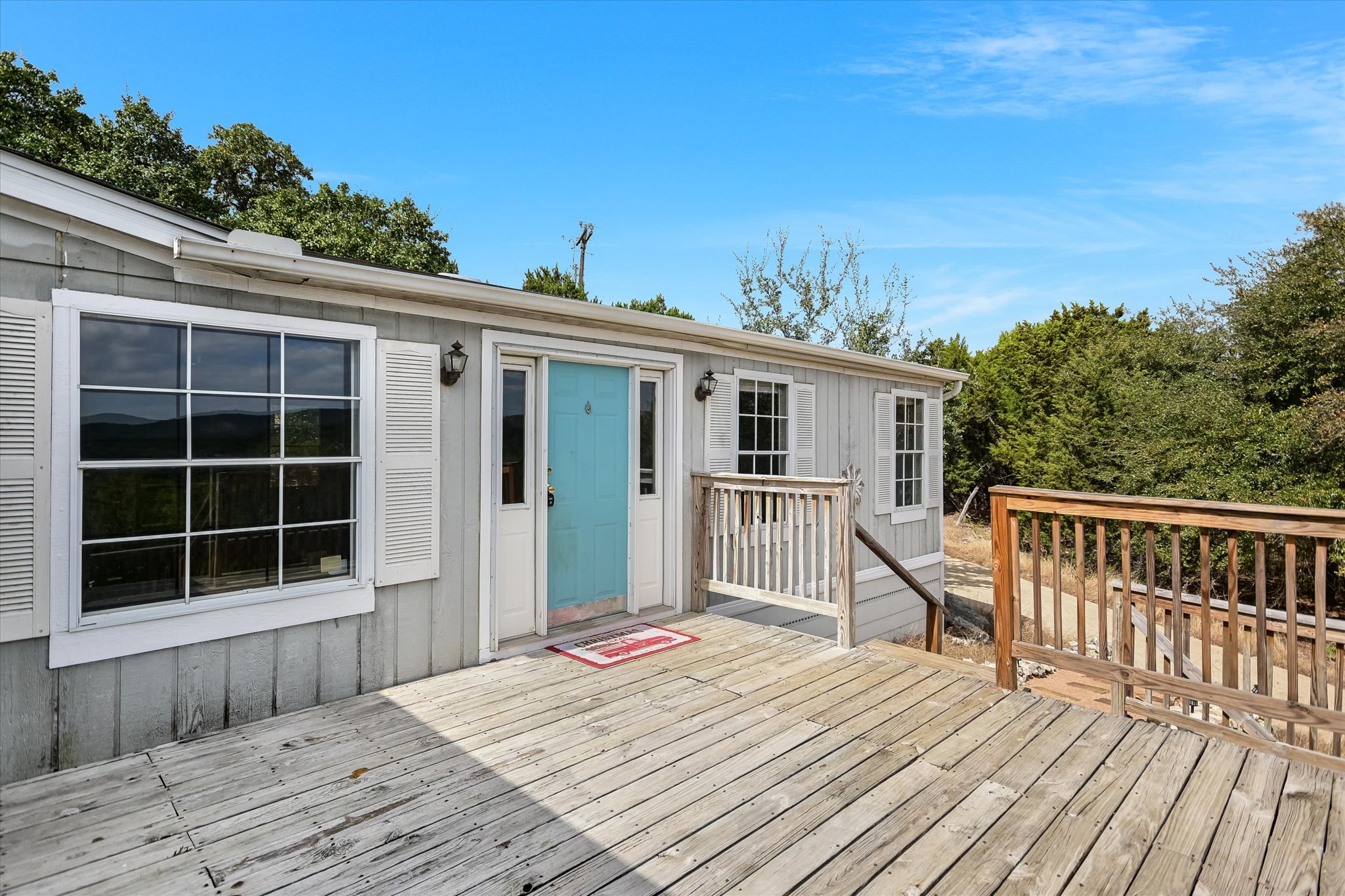 217 Rousey Street Canyon Lake, TX 78133 - Photo 7 of 25 a view of a house with a wooden deck
