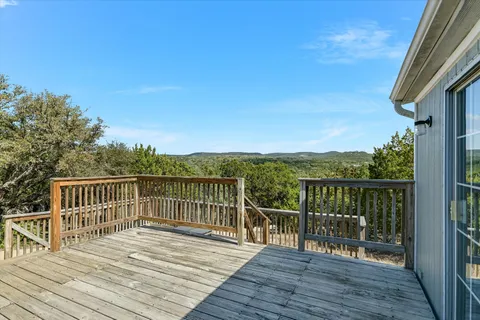 a view of a wooden deck with a lake