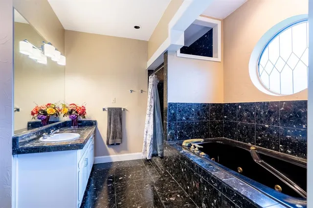 a bathroom with a bathtub and a sink