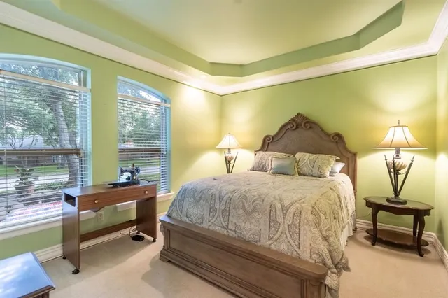 a bedroom with a bed and large window