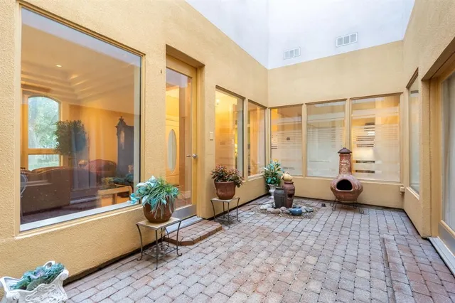a living room with furniture and large windows