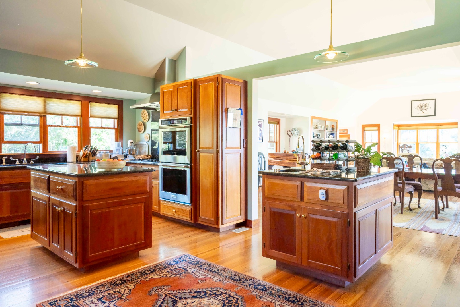 135 Capawock Road West Tisbury, MA 02568 - Photo 16 of 25 a living room with stainless steel appliances kitchen island granite countertop a refrigerator a stove top oven and a dining table with wooden floor