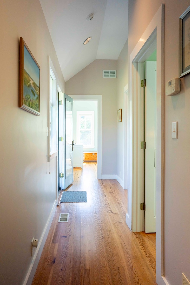 135 Capawock Road West Tisbury, MA 02568 - Photo 19 of 25 a view of a hallway with wooden floor and a bathroom