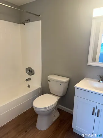 a bathroom with a toilet a sink and bathtub