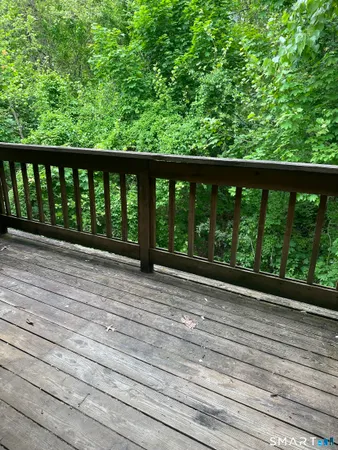 a view of balcony with deck and yard