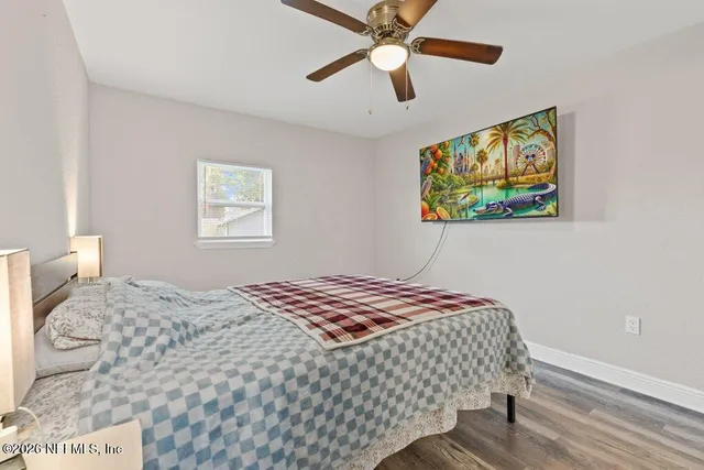 a bedroom with a bed and a painting on the wall