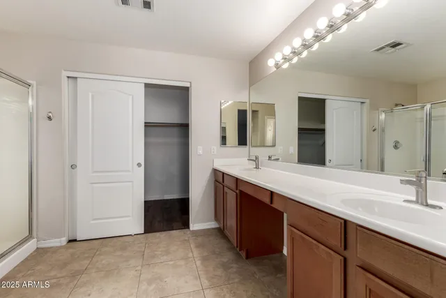 a spacious bathroom with a double vanity sink mirror and toilet